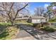 Exterior image showcasing a home with a three-car garage and long driveway at 4 Brookside Dr, Greenwood Village, CO 80121