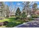 Charming two story home with mature trees surrounding and a three car garage on the right at 4 Brookside Dr, Greenwood Village, CO 80121
