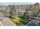 Exterior shot showing a beautiful two-story home with mature trees and well-manicured landscaping at 4 Brookside Dr, Greenwood Village, CO 80121