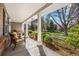 Inviting front porch with comfortable seating and views of beautiful landscaping and mature trees at 4 Brookside Dr, Greenwood Village, CO 80121