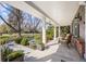 Inviting front porch with comfortable seating and beautiful views of the landscaped yard at 4 Brookside Dr, Greenwood Village, CO 80121