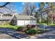 Three car garage with beautiful landscaping, mature trees, and a basketball hoop at 4 Brookside Dr, Greenwood Village, CO 80121