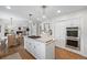 Open kitchen with stainless steel appliances, white cabinetry, hardwood floors, and a center island at 4 Brookside Dr, Greenwood Village, CO 80121