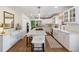 Spacious white kitchen featuring stainless steel appliances, hardwood floors, and marble countertops at 4 Brookside Dr, Greenwood Village, CO 80121