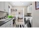 Well-equipped laundry room with a sink, lots of storage, and an adjacent office space at 4 Brookside Dr, Greenwood Village, CO 80121