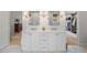 Bright bathroom featuring double sinks, vanity and a walk in closet at 4 Brookside Dr, Greenwood Village, CO 80121