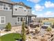 Backyard featuring a patio with a fire pit, a deck with a grill, a hot tub, and landscaping at 3038 Blithe Pt, Castle Rock, CO 80108