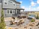 Serene backyard with a fire pit, a hot tub, a deck, and views of the surrounding community at 3038 Blithe Pt, Castle Rock, CO 80108