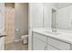 Well-lit bathroom featuring a single sink vanity, toilet, and shower with curtain at 3038 Blithe Pt, Castle Rock, CO 80108