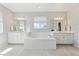 Bright and airy bathroom featuring dual vanities, a soaking tub, and clean, contemporary finishes at 3038 Blithe Pt, Castle Rock, CO 80108