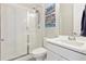 Modern bathroom featuring a glass-enclosed shower and a contemporary vanity with clean lines and fixtures at 3038 Blithe Pt, Castle Rock, CO 80108
