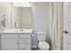Bathroom with a white vanity, a large mirror, a toilet, and a shower with a curtain at 3038 Blithe Pt, Castle Rock, CO 80108
