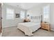 Cozy bedroom featuring neutral walls, carpet, and a neatly made bed, next to a wood nightstand at 3038 Blithe Pt, Castle Rock, CO 80108