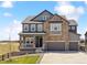 Beautiful two-story home boasts a stone facade, three-car garage, and a welcoming front porch at 3038 Blithe Pt, Castle Rock, CO 80108