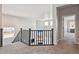 A carpeted hallway with nice railing overlooks the open-concept living space at 3038 Blithe Pt, Castle Rock, CO 80108