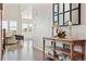 Bright hallway showcases a decorative console table and leads to a living space with abundant natural light at 3038 Blithe Pt, Castle Rock, CO 80108