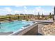 Inviting hot tub with scenic views, and a patio area with comfortable seating around a fire pit at 3038 Blithe Pt, Castle Rock, CO 80108