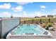 A luxurious hot tub with views of the community, adjacent to a patio featuring a fire pit at 3038 Blithe Pt, Castle Rock, CO 80108