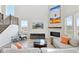 Bright living room with fireplace, TV, sectional sofa and expansive windows with scenic views at 3038 Blithe Pt, Castle Rock, CO 80108