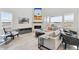 Bright, open living room with fireplace, large windows, and modern furnishings at 3038 Blithe Pt, Castle Rock, CO 80108