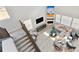 Bright living room boasts modern decor, a fireplace, lots of windows, and comfortable seating, perfect for relaxation at 3038 Blithe Pt, Castle Rock, CO 80108
