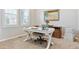Well-lit home office featuring a white desk, neutral carpet, and a serene artwork piece at 3038 Blithe Pt, Castle Rock, CO 80108