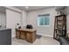 Finished basement office with a large desk and built-in shelving at 8901 S Ukraine Ct, Aurora, CO 80016