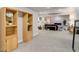 Finished basement with built-in shelving and a comfortable sitting area at 8901 S Ukraine Ct, Aurora, CO 80016