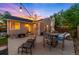 Charming backyard with a patio, fire pit, and string lights, creating an inviting outdoor retreat at 5125 Umatilla St, Denver, CO 80221