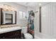 Well-lit bathroom with a bathtub, shower, and stylish vanity, creating a clean and refreshing space at 5125 Umatilla St, Denver, CO 80221