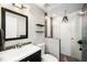 Modern bathroom with sleek fixtures, textured shower, and stylish vanity, providing a spa-like experience at 5125 Umatilla St, Denver, CO 80221