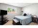 Bright bedroom with a comfortable bed, side table, and a large window, creating a serene retreat at 5125 Umatilla St, Denver, CO 80221