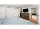 Spacious bedroom with hardwood floors, a comfortable bed, and closet doors, offering storage and style at 5125 Umatilla St, Denver, CO 80221