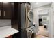 Efficient laundry room with a stacked washer and dryer, and granite countertop, offering convenience at 5125 Umatilla St, Denver, CO 80221