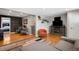 Inviting living area with a brick accent wall, hardwood floors, and comfortable seating, perfect for relaxation at 5125 Umatilla St, Denver, CO 80221
