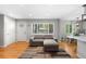 Cozy living room featuring a comfortable sofa, hardwood floors, and a large window offering plenty of natural light at 5125 Umatilla St, Denver, CO 80221