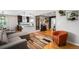 Open-concept living space with hardwood floors, modern furnishings, and seamless flow to the kitchen and dining area at 5125 Umatilla St, Denver, CO 80221