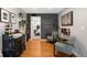 Cozy living room featuring hardwood floors, brick accent wall, and stylish decor, creating a welcoming atmosphere at 5125 Umatilla St, Denver, CO 80221