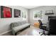 Bright office with a comfortable sofa, a desk, and framed posters, perfect for remote work at 5125 Umatilla St, Denver, CO 80221
