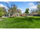 Large, green backyard with mature trees and a detached garage at 185 S Hoyt St, Lakewood, CO 80226