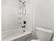 Bathroom featuring a shower-tub combo and a standard toilet at 185 S Hoyt St, Lakewood, CO 80226