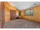 Bedroom with paneled walls, carpet, and closet at 185 S Hoyt St, Lakewood, CO 80226