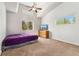Bright bedroom featuring a vaulted ceiling, neutral walls, plush carpet, and a view of the outdoors at 185 S Hoyt St, Lakewood, CO 80226