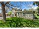 Exterior shot of light green siding and well-maintained lawn, accented by mature trees providing ample shade at 185 S Hoyt St, Lakewood, CO 80226