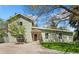 Charming home with light green siding and a welcoming stone-accented entrance, plus mature trees on a grassy lot at 185 S Hoyt St, Lakewood, CO 80226