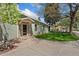 Exterior view of a light green home featuring a stone-accented entrance and a neatly landscaped front yard at 185 S Hoyt St, Lakewood, CO 80226