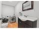 Laundry room with laundry machines, neutral walls, tile floors, and a sink at 185 S Hoyt St, Lakewood, CO 80226