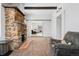 Charming living room showcasing a stone fireplace and neutral carpet, connecting to other rooms in an open layout at 185 S Hoyt St, Lakewood, CO 80226