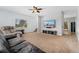 Spacious carpeted living room with natural light, ceiling fan, and media center for comfortable living and entertaining at 185 S Hoyt St, Lakewood, CO 80226