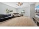 Bright living room with neutral carpet, showcasing natural light, comfortable seating, and a modern media setup at 185 S Hoyt St, Lakewood, CO 80226